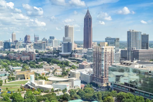 A breathtaking aerial view of the Atlanta skyline with high-rise buildings under a clear blue sky.